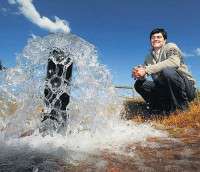 Splash: Hamish Crawford with the flow from the groundwater pump, which helps keep groundwater levels in check.